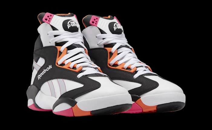 View of white, black, and orange Reebok sneakers.